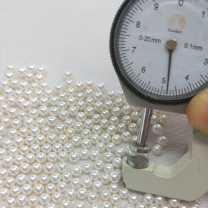 Close-up of precision half-drilled round freshwater cultured pearls for earring studs