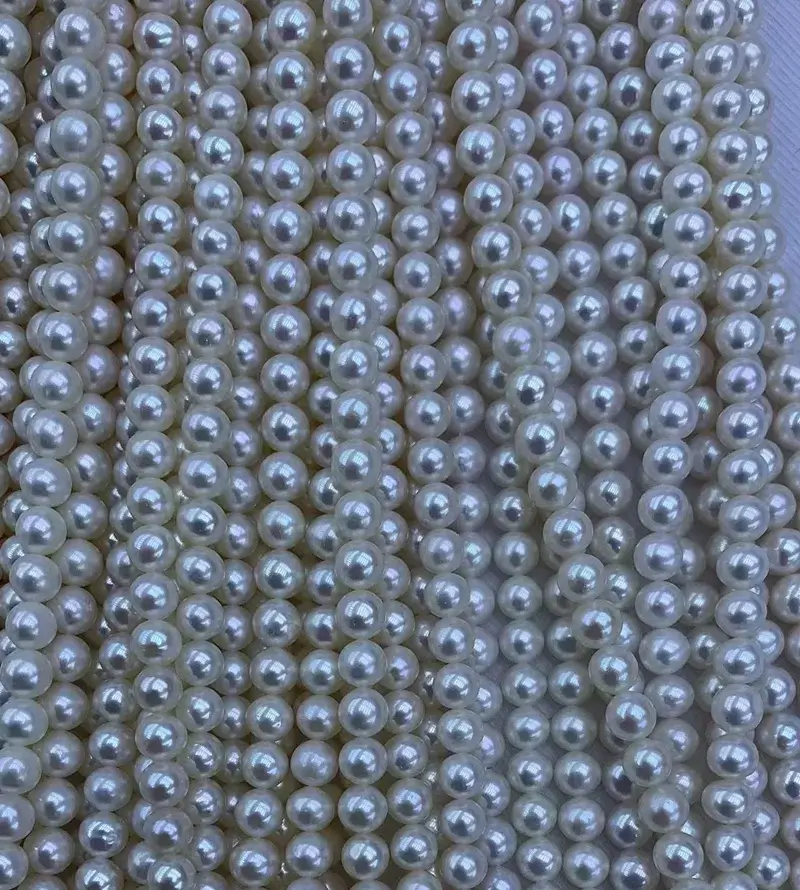 Close-up of natural white freshwater loose pearls showing clean surface and high luster for tiny pearl necklace supply