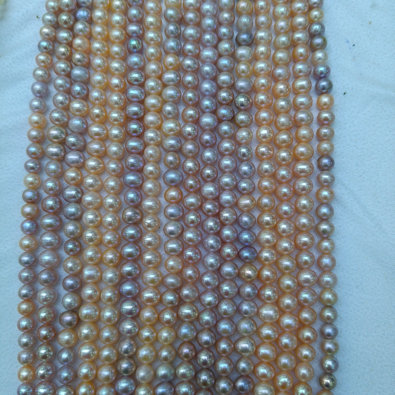 Pink and lavender oval freshwater pearl strands with natural color tones and high luster