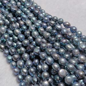 Intense metallic blue glow on gray pearl nugget strands for grey pearl necklace designs