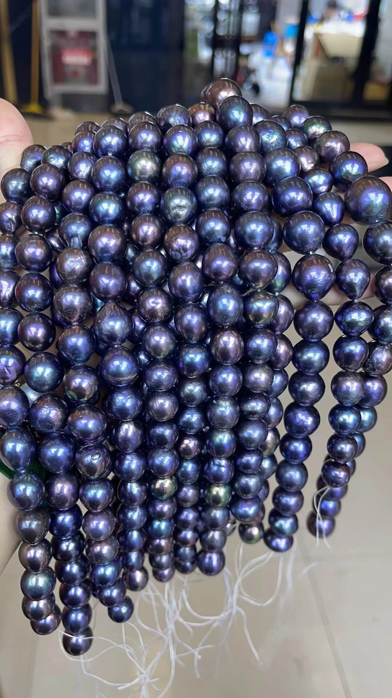 A conceptual visualization of high-value, statement peacock pearl earrings, featuring the 12-14mm premium teardrop Edison nucleated pearls shown in the wholesale listing.