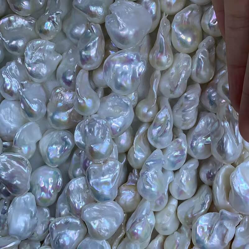 Close-up shot of large 13-15mm fireball shape freshwater baroque pearls, showcasing clean surfaces and strong natural white iridescence.
