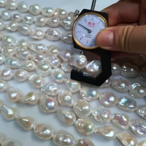 Close-up shot of natural white baroque fireball pearls showing high luster and clean surface for quality assurance