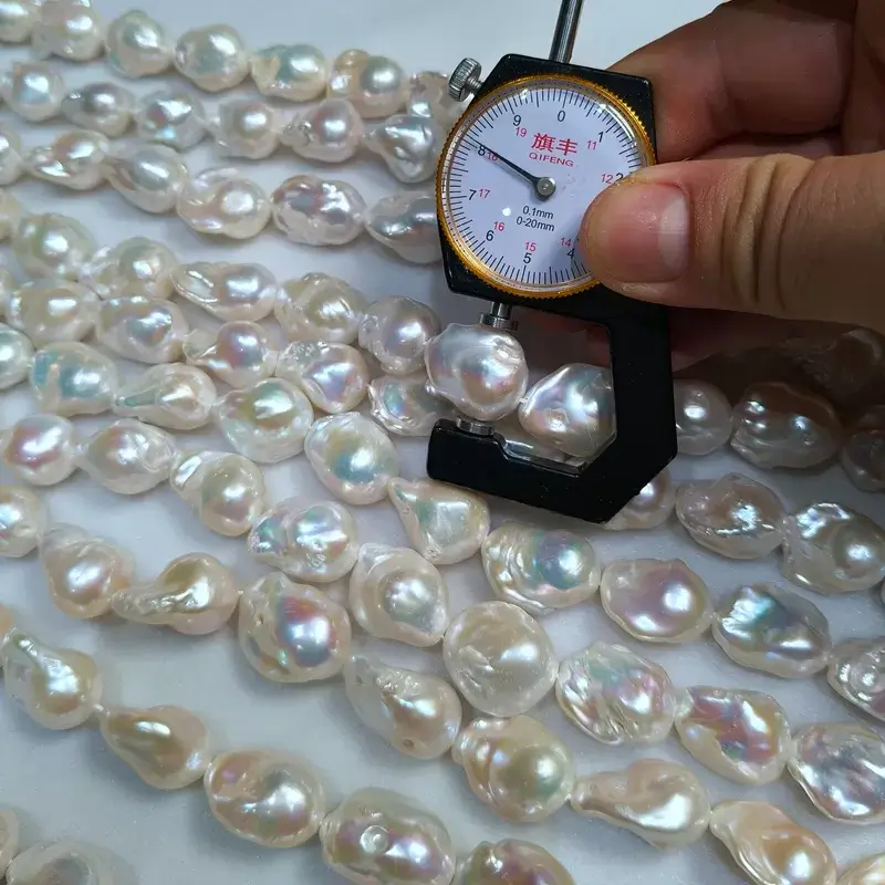 Close-up shot of natural white baroque fireball pearls showing high luster and clean surface for quality assurance