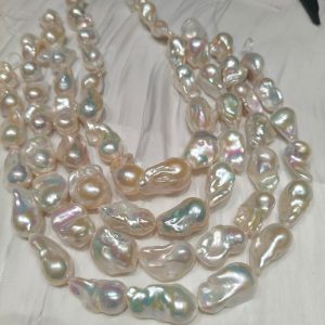 Close-up of large white baroque freshwater pearls with intense metallic luster and fireball shape