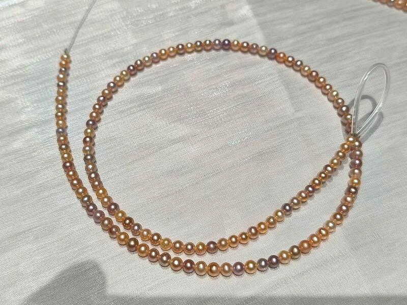 A single continuous strand of 3mm micro pearls with uniform drill holes, ideal for intricate delicate jewelry design.