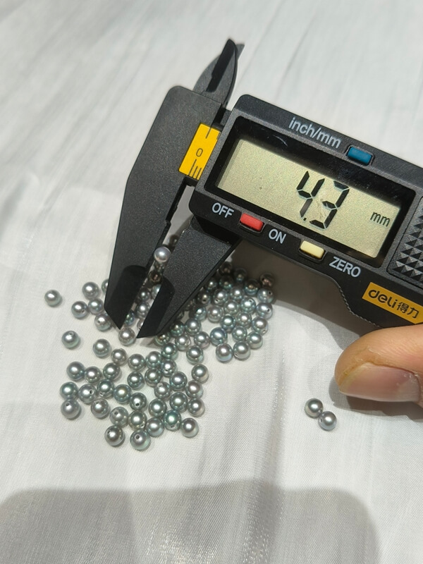 Precision-sorted 4.3mm gray half-drilled round freshwater pearls in matching pairs for small stud earrings.