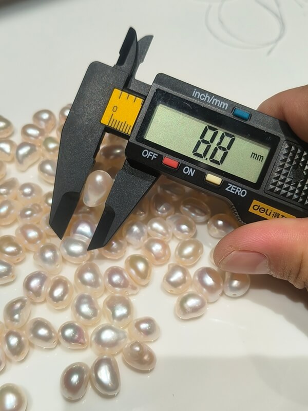 A selection of 8mm to 10mm cashew bean shaped baroque pearls showing consistent sizing for independent designers