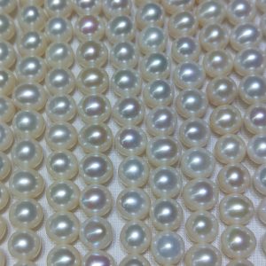 Wholesale B2B supplier showcasing multiple strands of premium 9-10mm high luster potato freshwater pearls.