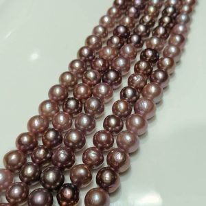 Close-up of semi-finished dark Edison pearl strands with unique natural texture and ripples for designers.