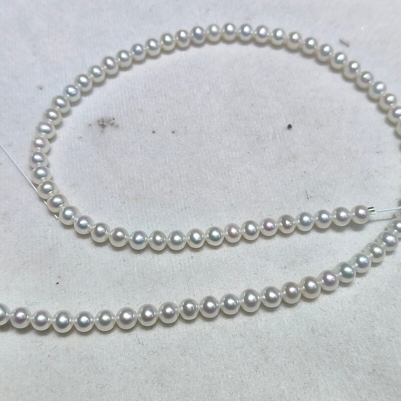 Close-up of AA+ grade high luster 5mm loose pearl beads for professional jewelry designers