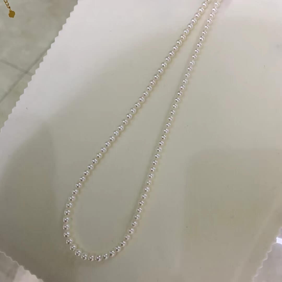 Full view of a timeless 18-inch round white pearl strand choker necklace in a dainty 4mm size, supplied in bulk at factory prices for jewelry brands and designers.
