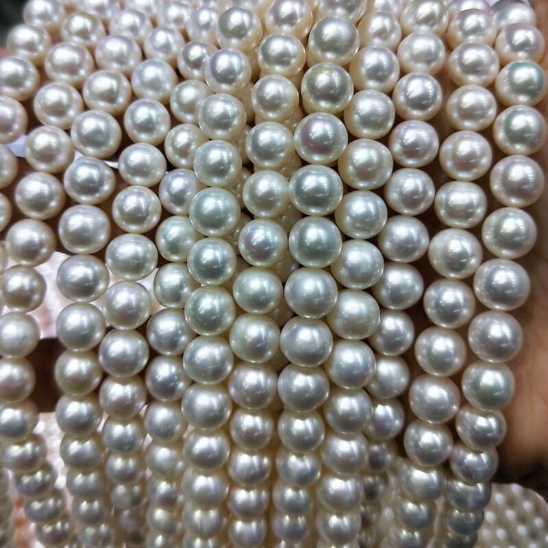 Large inventory stock of 8mm classic white freshwater cultured pearl loose stones strands, prepared for high-volume custom pearl necklace wholesale orders.