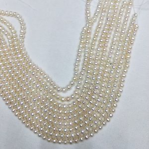 Close-up of 5mm semi-round natural white freshwater pearls with high luster for bridal jewelry