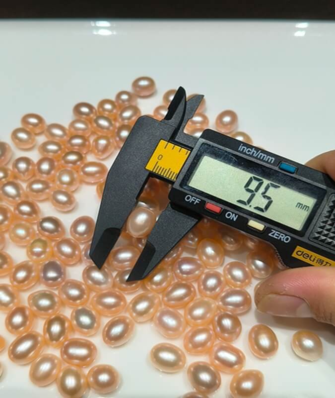 Caliper-calibrated 8.5mm by 11mm organic water drop shape pearls with mirror luster