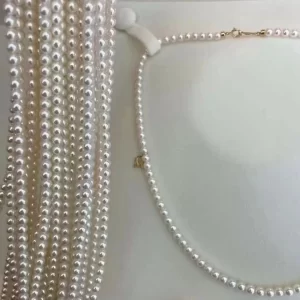 A 42cm high luster 5mm round freshwater pearl strand displayed as a delicate necklace