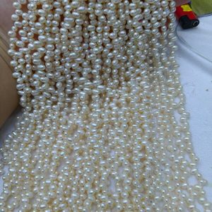 Wholesale freshwater rice pearl strands in bulk, featuring classic natural white top-to-bottom drilled semi-finished supplies for jewelry designers.