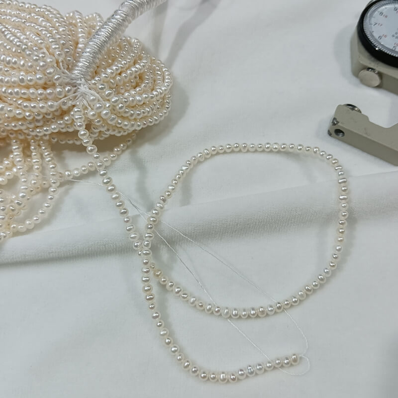 Fully drilled 2mm tiny freshwater pearls ready for effortless stringing into a trendy tiny pearl necklace.