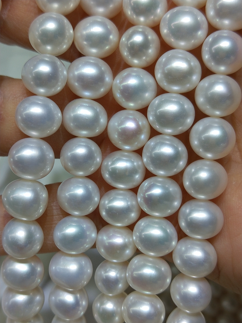 Measuring a 16-inch natural white off-round potato freshwater pearl strand for jewelry making.