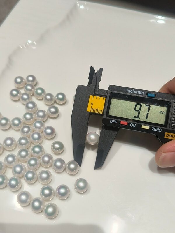 Wholesale lot of 9.7-10.1mm freshwater pearl ring material, featuring untreated natural white Edison round pearls for convertible jewelry collections and high-end goldsmithing.