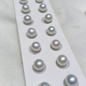 Half-drilled premium freshwater Edison pearl pairs ready for stud earring jewelry making, showcasing a flawless round profile.