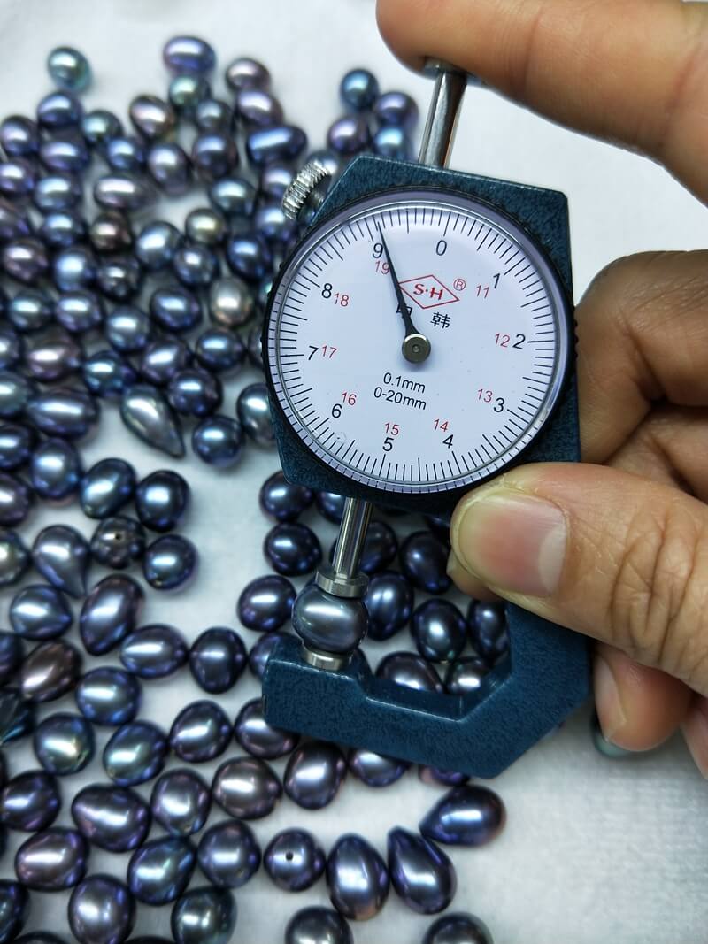 Bulk natural cultured freshwater pearls in peacock blue iridescent dark tone