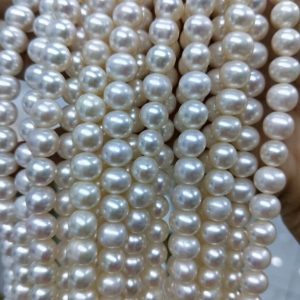 Close up of high luster natural white freshwater pearls showing surface and shape