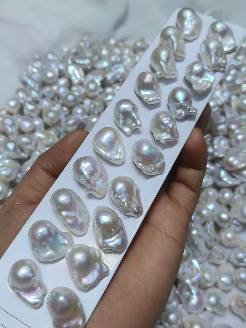 Premium irregular baroque pearl pairs with pink and green metallic overtones ready for custom studio earrings.