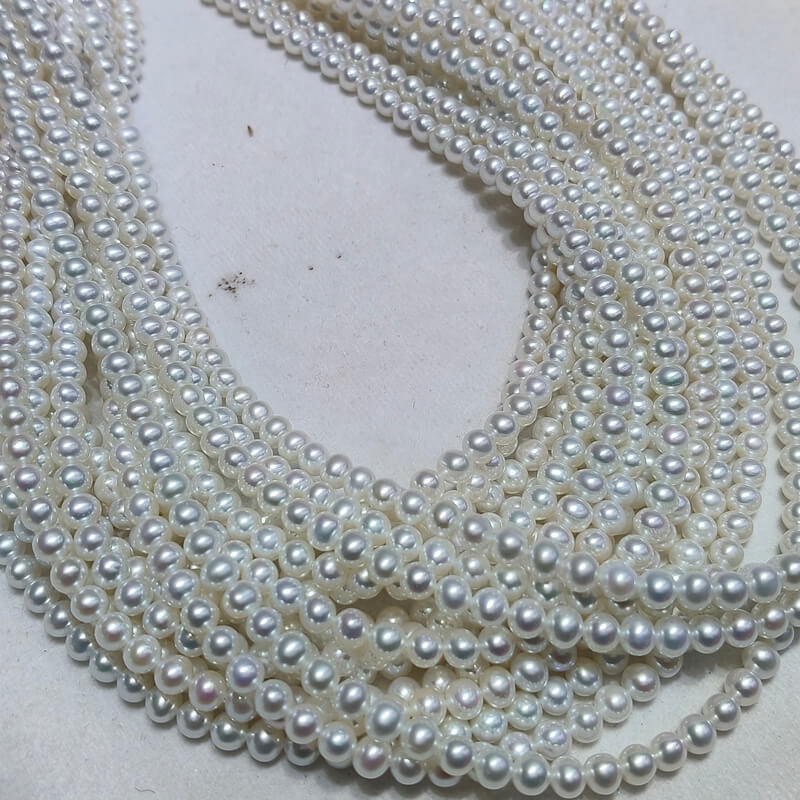 15 inch natural white near round freshwater pearl strands sold in bulk for boutique brands