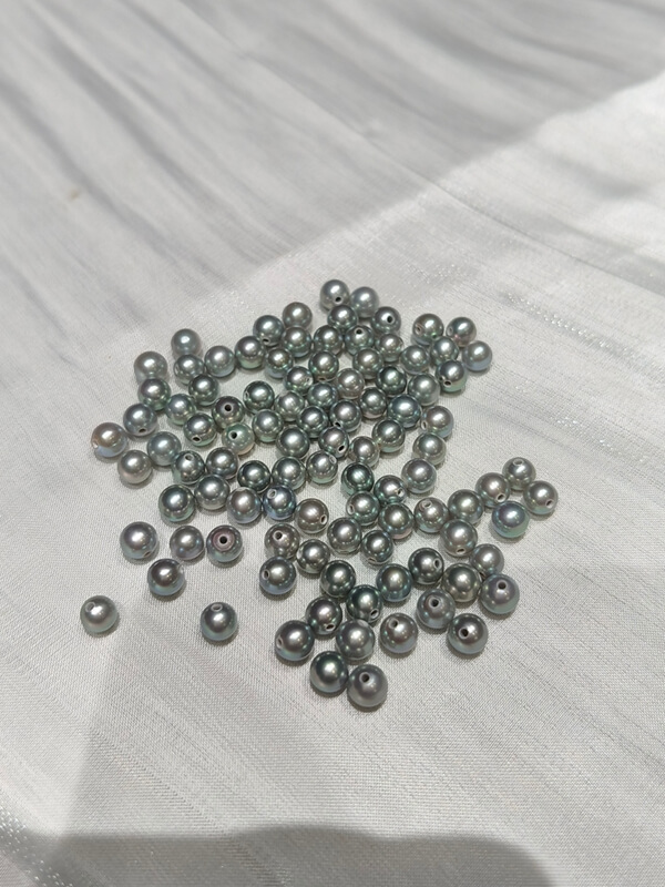 Wholesale loose gray half drilled round pearls ready to mount on sterling silver or gold earring posts.