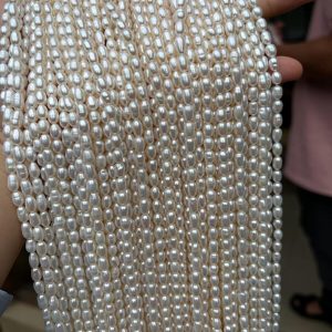 Premium high luster 4mm white rice shaped freshwater pearls in bulk for independent designers.
