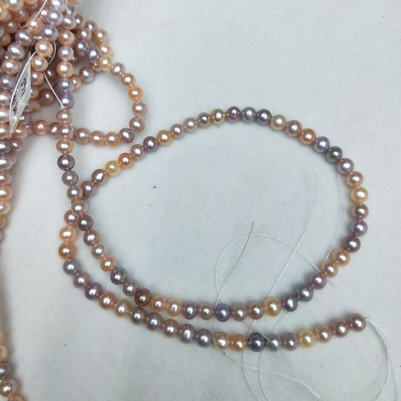 Close-up of high luster pink and purple mixed freshwater cultured pearls for jewelry designers