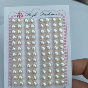 A finished pair of elegant pearl wedding earrings featuring the same high-luster, 7mm natural white freshwater button pearls shown on the wholesale display card.