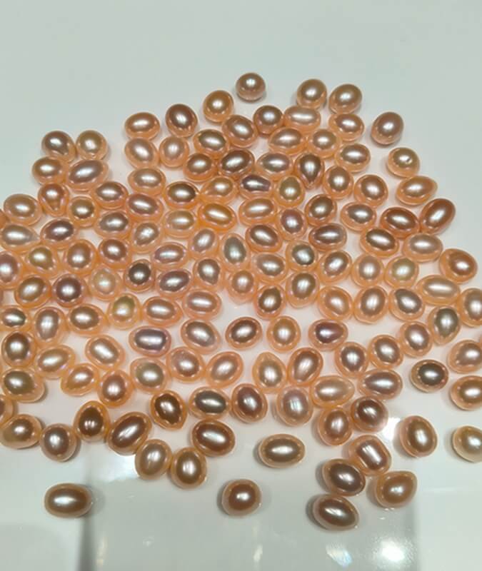 Precision half drilled peach pink drop pearl beads with 0.8mm top-drilled hole optimized for peg settings