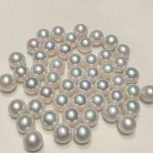 undrilled white Edison round pearl on a white background, demonstrating the precise calibration ideal for setting custom pearl rings.