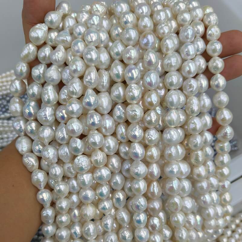 High luster teardrop shape white ripple pearls 11mm to 13mm ideal for luxury bridal pearl drop earrings and single pearl pendants.