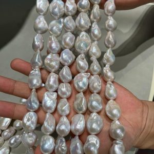 Multiple matched baroque style pearl strands held in hands, displaying uniform sizes and shapes perfectly optimized for designing consistent pearl drop earrings and couture necklaces.