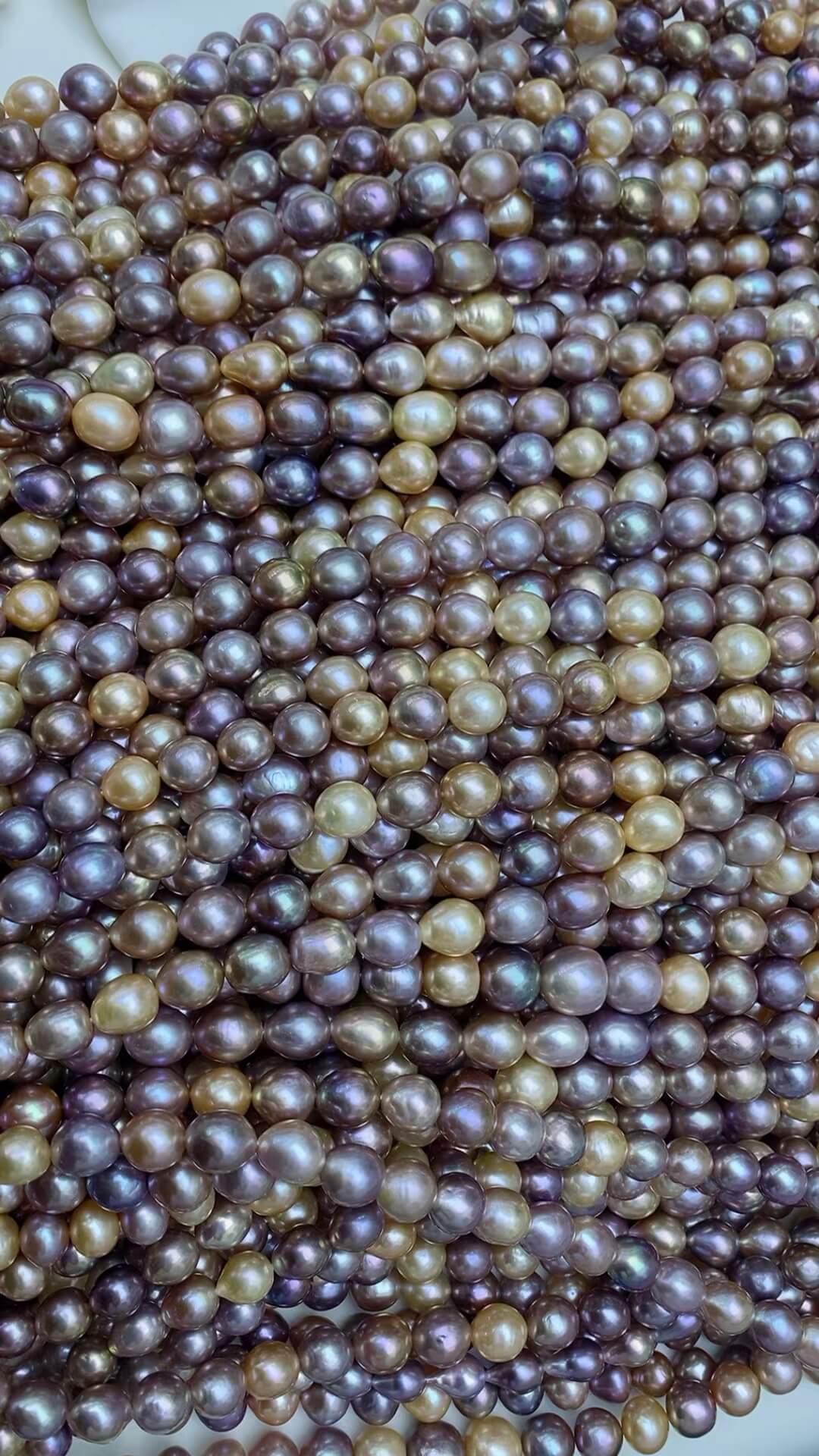 Bulk wholesale 10mm multicolor baroque pearl strands with high metallic luster for making trendy pearl necklaces.