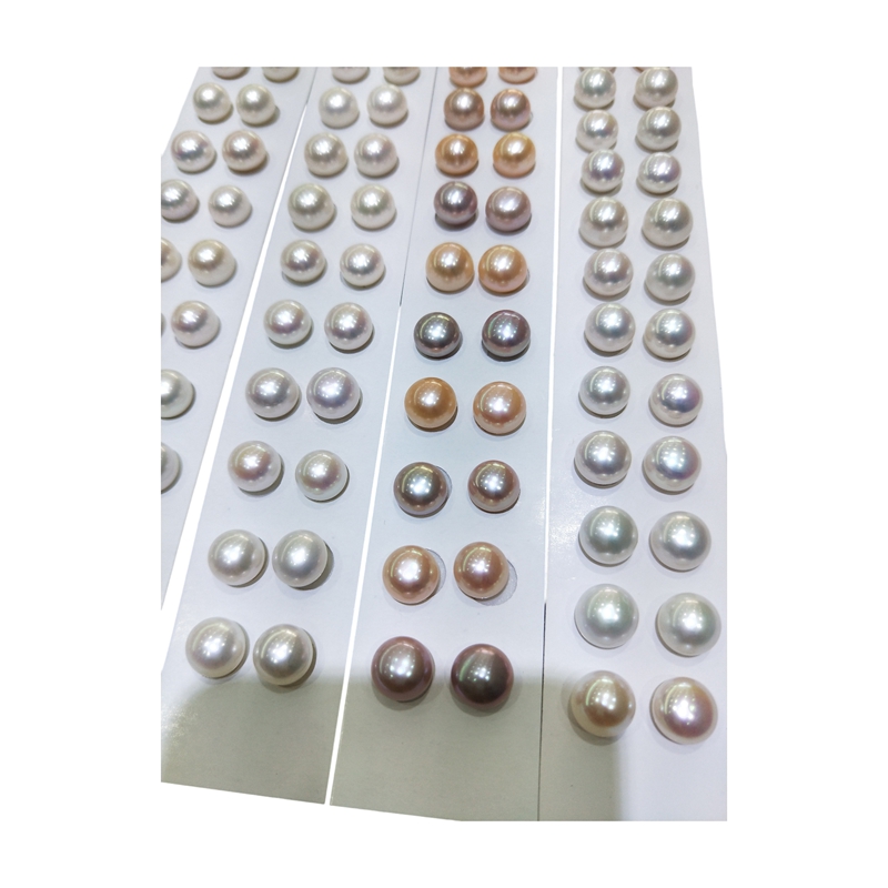 Bulk supply of matched pairs button freshwater pearl beads in white, pink, and lavender colors on paper cards for earring studs.