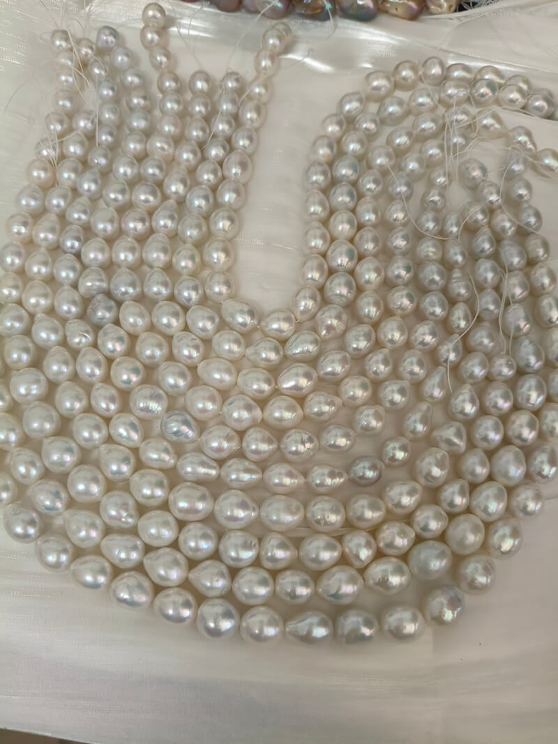 High-luster white freshwater baroque pearl strands in bulk for wholesale jewelry making and suppliers.