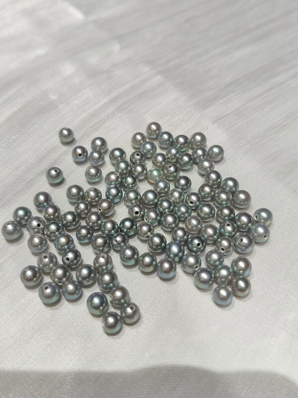 Caliper measuring micro 4.3mm gray half drilled pearls for dainty studs and minimalist jewelry making.