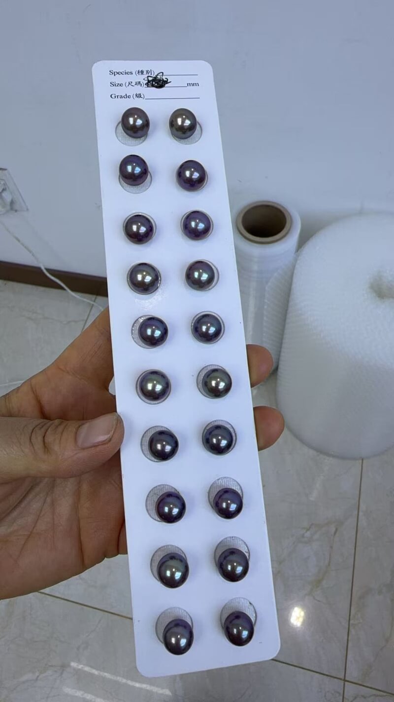 Wholesale tray of matched pairs of metallic peacock blue and violet Edison pearls for earrings