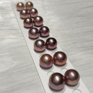 Wholesale lot of oversized 13mm deep purple loose Edison pearls with excellent metallic overtones.