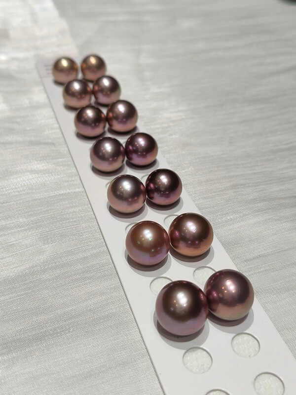 Wholesale lot of oversized 13mm deep purple loose Edison pearls with excellent metallic overtones.